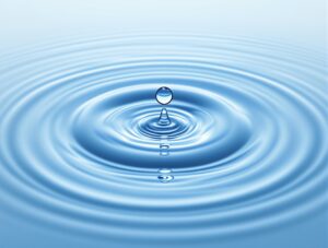 Visual representation of ripples spreading outward from a central meditation figure, with each ripple containing symbols of positive life changes and wealth building